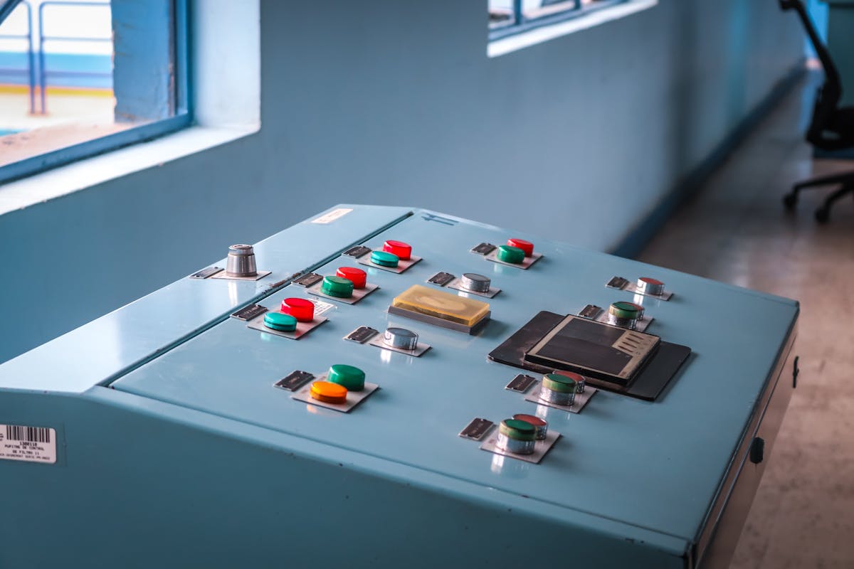 Industrial control panel with colored buttons in a facility
